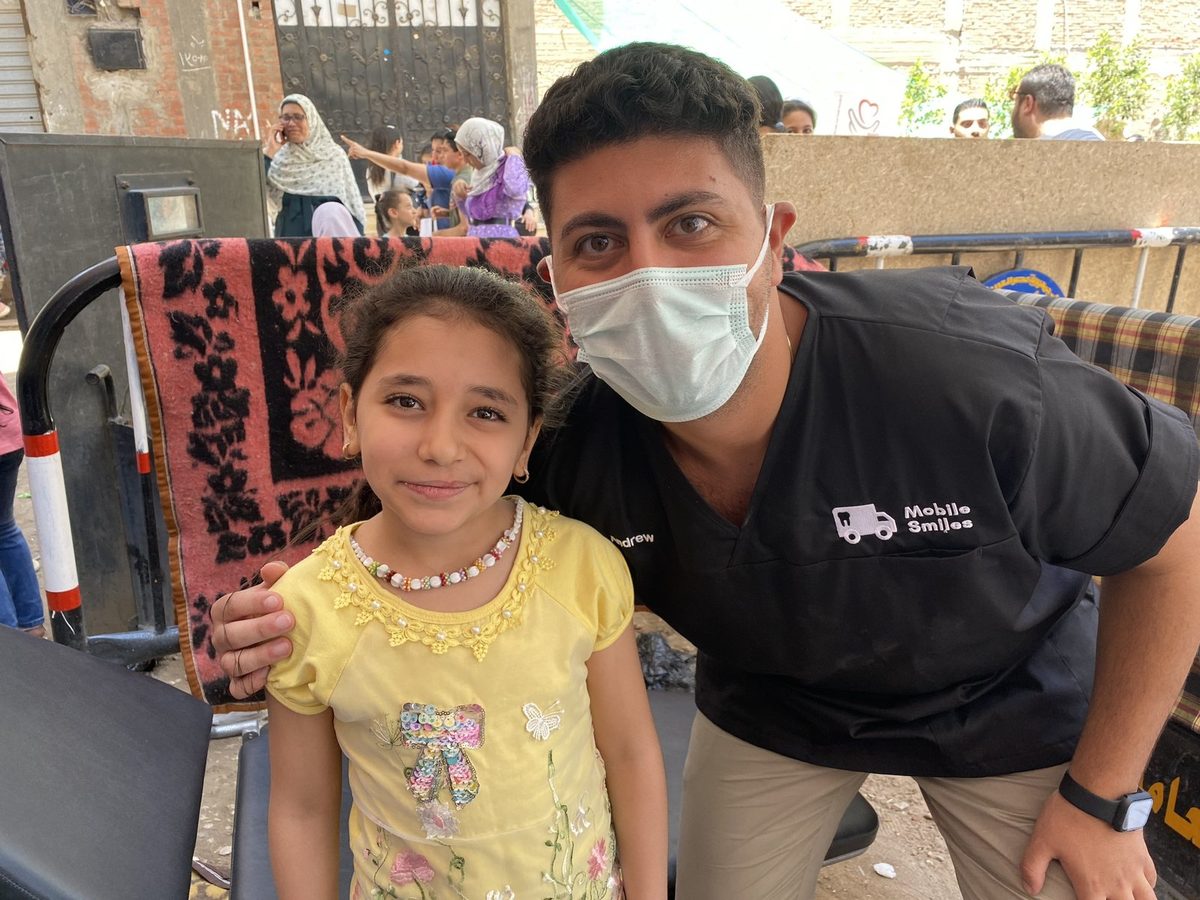 Dr Andrew with a young patient on a charity mission in Egypt