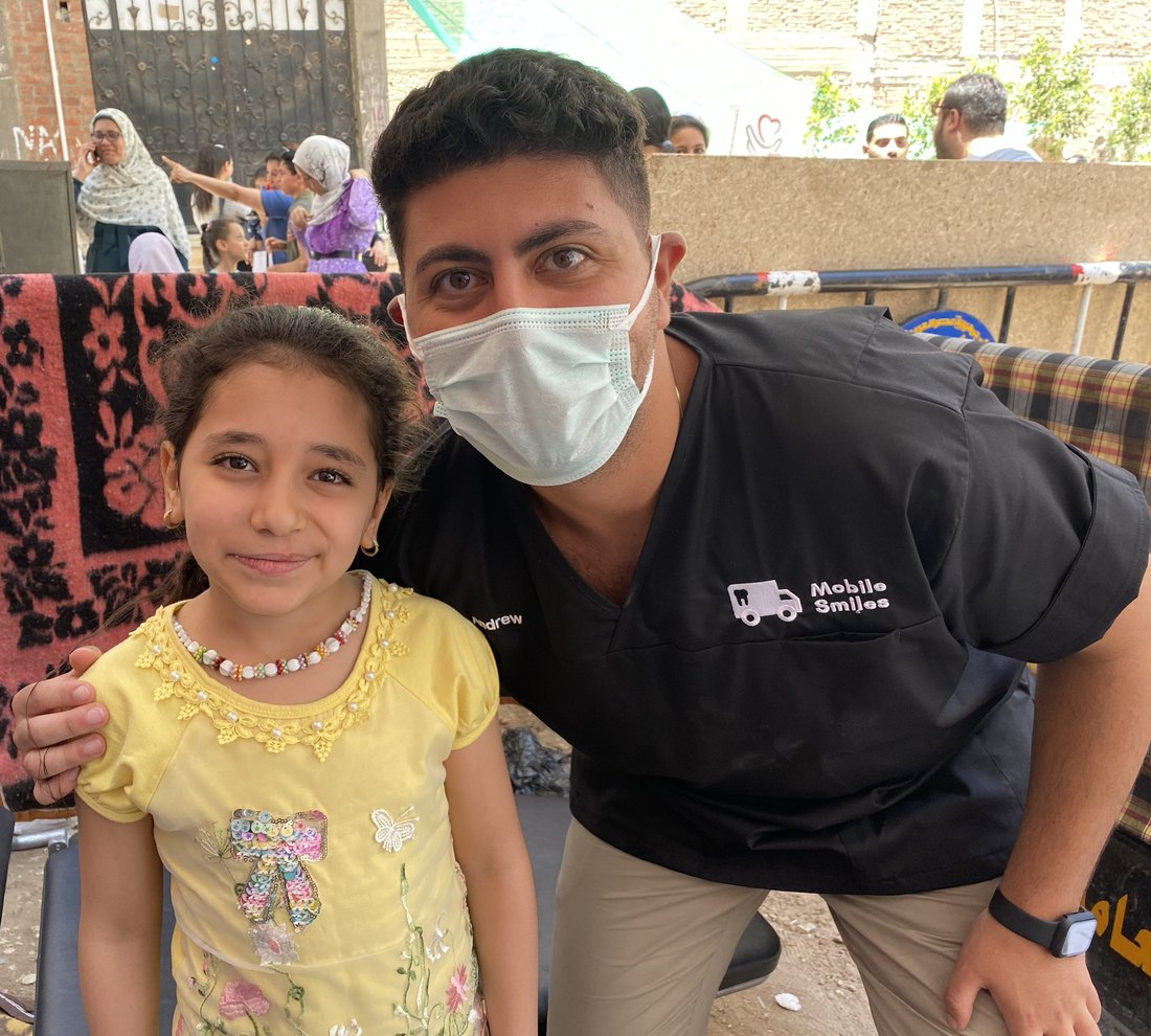 Dr Andrew with a young patient on a Mobile Smiles charity mission in Egypt