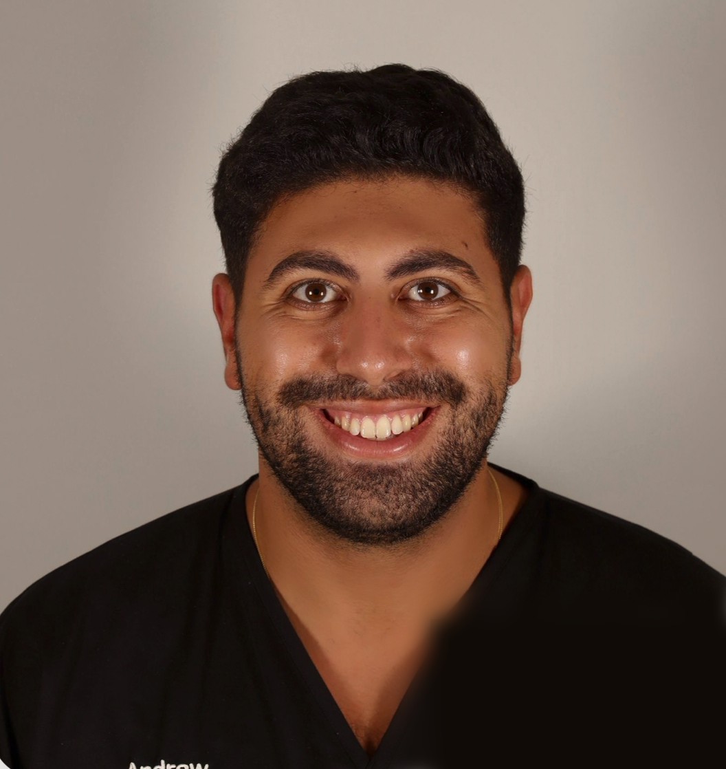 Dr Andrew El-Khanagry smiling in dark scrubs